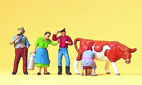 Paysans traiant une vache